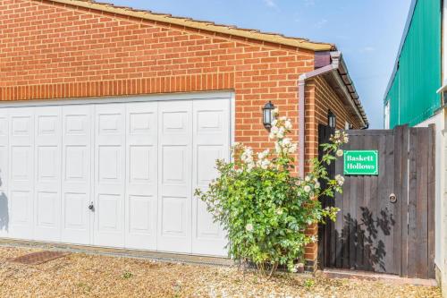 a brick building with a white garage door at 1 Bed in Flore oc-b32437 in Flore
