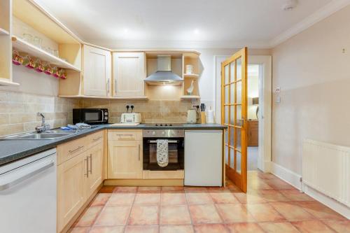 a kitchen with wooden cabinets and a stove top oven at 2 Bed in Methven oc-c32362 in Methven