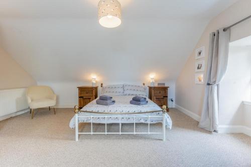 a bedroom with a white bed and a chair at 2 Bed in Methven oc-c32362 in Methven