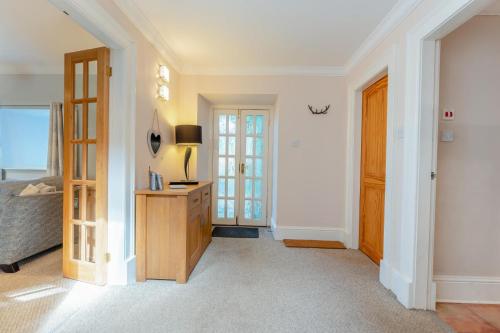 a hallway with a bed and a dresser and a door at 2 Bed in Methven oc-c32362 in Methven