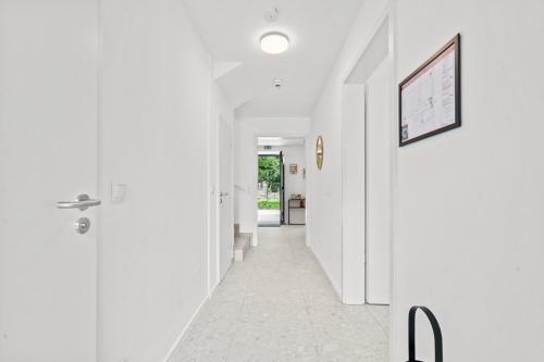 a hallway with white walls and a door at Gîte Lasauvage 84 in Ferme Thibesart