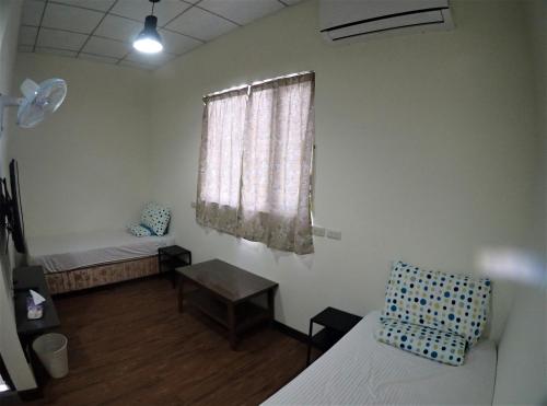 a room with two beds and a window at Fire Island Guest House in Green Island