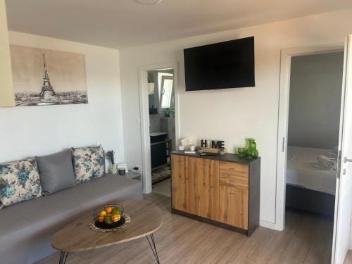 a living room with a couch and a table at Mobile home La Bella in Drage