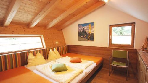 a bedroom with a bed in a room with a window at Alpin Chalet Flachau in Flachau