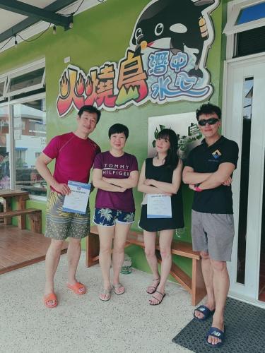 a group of people standing in front of a building at Fire Island Guest House in Green Island
