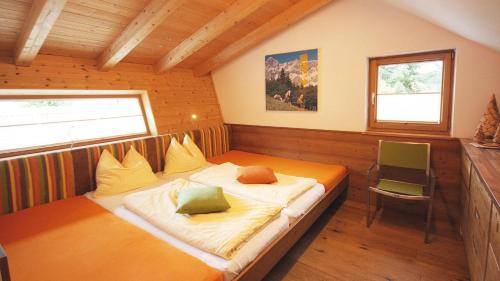 a bedroom with a bed in a room with a window at Alpin Chalet Flachauwinkl in Flachau