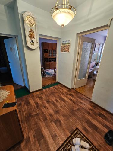 an empty living room with wood floors and a chandelier at Иссык-Куль, Аврора in Bulan Sogottuu