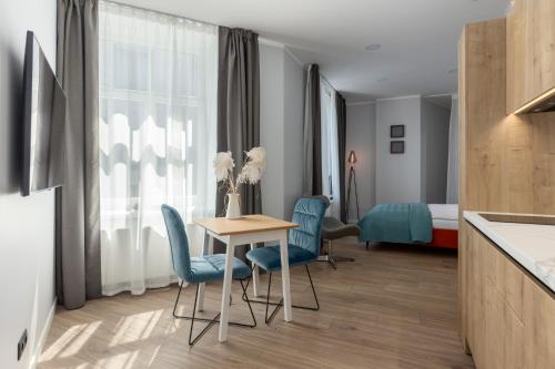 a hotel room with a table and chairs and a bed at P6-A Riga Old Town Apartments in Rīga