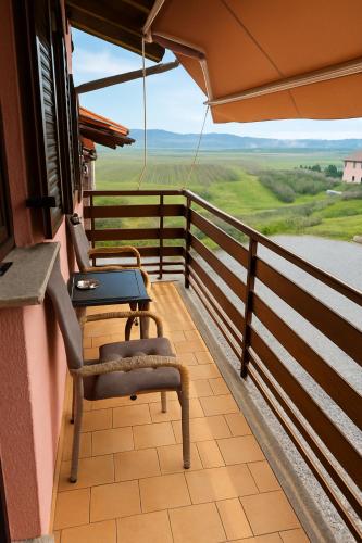 a balcony with chairs and a table and a view at Hiša Vanda in Dobrovo