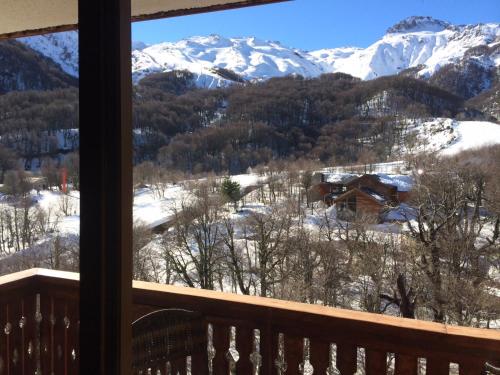 a view of snow covered mountains from a balcony at Departamentos Exclusivos Termas de Chillán in Nevados de Chillan