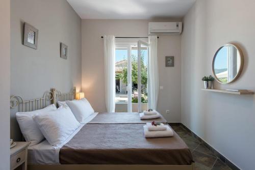 a bedroom with a bed with two towels on it at Luxurious Agios Georgios Villa Private Pool Villa Spyridoula Beach Paradise in Agios Georgios