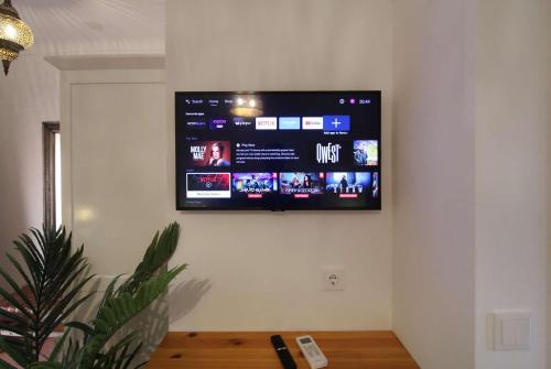 a flat screen tv hanging on a wall at Quinta do Canal in Vila Nova de Milfontes