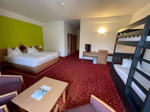 a hotel room with two beds and a bunk bed at Thermenhotel Vier Jahreszeiten in Lutzmannsburg