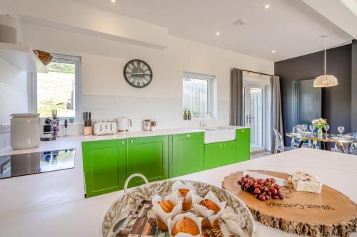 a kitchen with green cabinets and a plate of food on a table at 2 Bed in Newburgh oc-f32595 in Newburgh