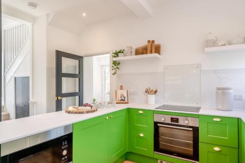 a kitchen with green cabinets and white counters at 2 Bed in Newburgh oc-f32595 in Newburgh