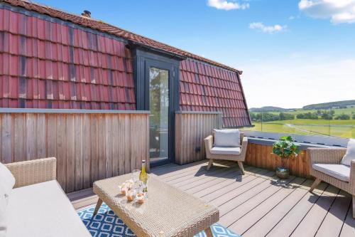 a deck with chairs and a table and a building at 2 Bed in Newburgh oc-f32595 in Newburgh