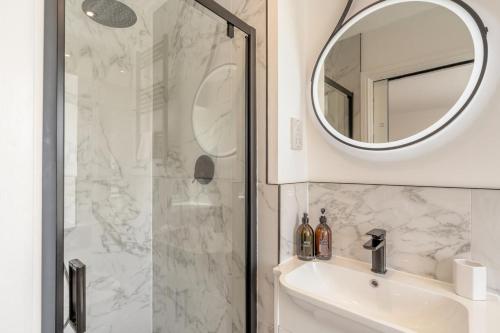 a bathroom with a shower and a sink and a mirror at 2 Bed in Newburgh oc-f32595 in Newburgh