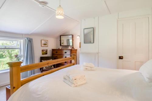 a bedroom with a white bed and a window at 2 Bed in Stalham oc-u32571 in Stalham