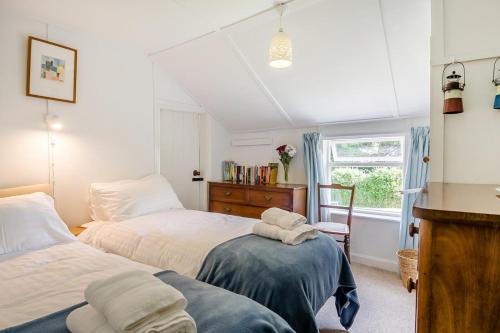 a bedroom with two beds and a window at 2 Bed in Stalham oc-u32571 in Stalham