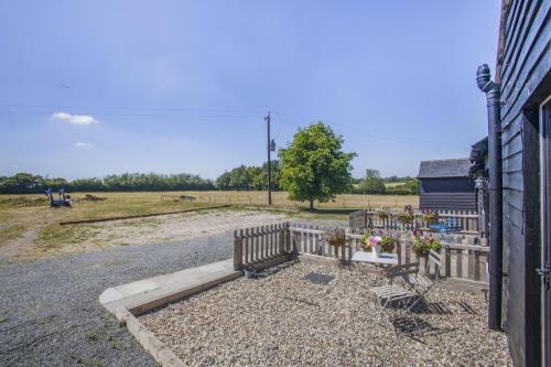 a fence with benches and flowers in a field at 1 Bed in Great Sampford oc-f32654 in Great Sampford