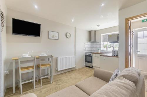 a living room with a couch and a kitchen at 1 Bed in Great Sampford oc-f32653 in Great Sampford