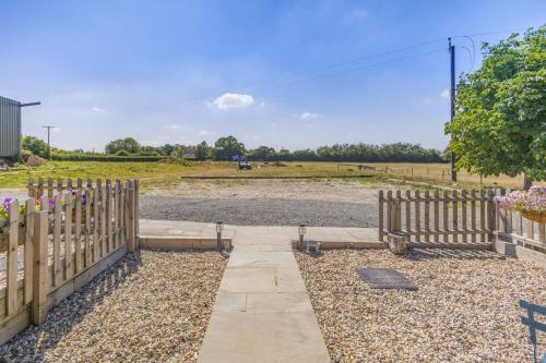 a wooden fence and a walkway in a field at 1 Bed in Great Sampford oc-f32653 in Great Sampford