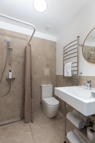 a bathroom with a white toilet and a sink at P6-A Riga Old Town Apartments in Rīga