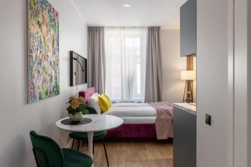 a hotel room with a bed and a table at P6-A Riga Old Town Apartments in Rīga