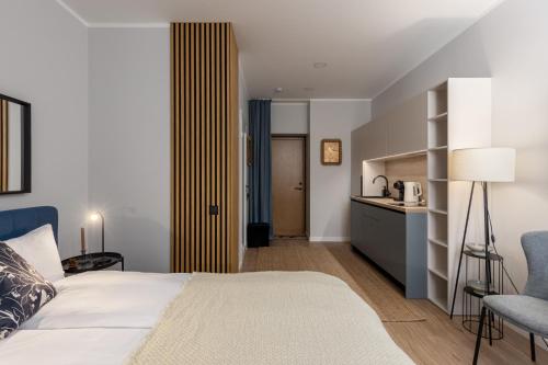 a hotel room with a bed and a kitchen at P6-A Riga Old Town Apartments in Rīga