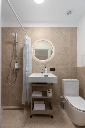 a bathroom with a sink and a toilet and a mirror at P6-A Riga Old Town Apartments in Rīga