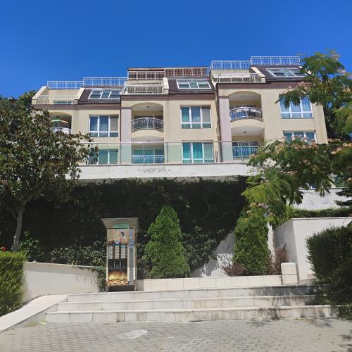 a building with a staircase in front of it at apartment VANESA in Kavarna