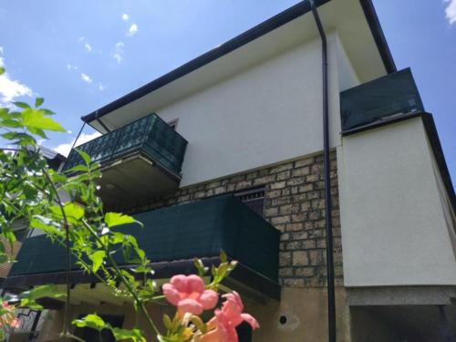 a house with a large window on the side of it at Hiža Guesthouse in Sarajevo