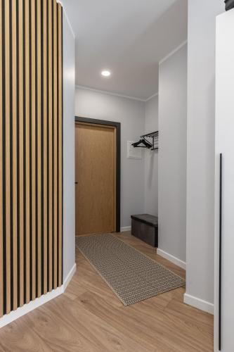 a hallway with a door and a rug at P6-A Riga Old Town Apartments in Rīga