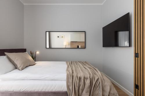 a bedroom with a bed with a mirror on the wall at P6-A Riga Old Town Apartments in Rīga