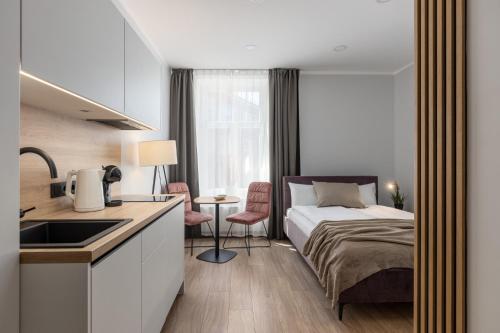 a bedroom with a bed and a kitchen with a sink at P6-A Riga Old Town Apartments in Rīga