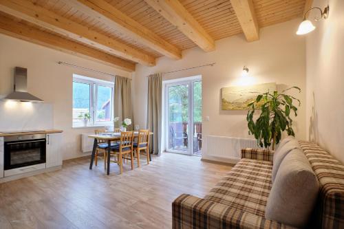 a living room with a couch and a table at Apartmány LehotSKI Guest House in Pavčina Lehota