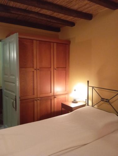 a bedroom with a bed and a closet at Volissos Sea View Maisonettes in Volissos