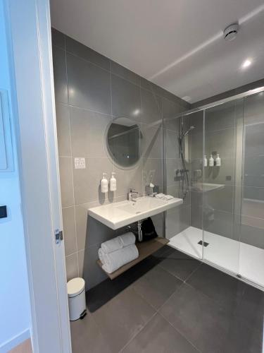 a bathroom with a sink and a shower at Spark By Hilton Madrid Alcala in Madrid