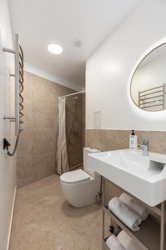 a bathroom with a sink and a toilet and a mirror at P6-A Riga Old Town Apartments in Rīga