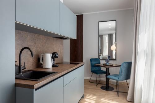 a kitchen with a sink and a table with chairs at P6-A Riga Old Town Apartments in Rīga