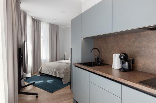 a kitchen with a sink and a bed in a room at P6-A Riga Old Town Apartments in Rīga