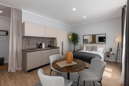 a kitchen and a bedroom with a bed and a table at P6-A Riga Old Town Apartments in Rīga
