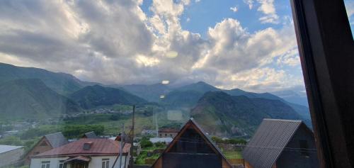 a view from a window of a town with mountains at Elnetsa Inn Kazbegi in Stepantsminda