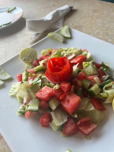 a pile of vegetables on a white cutting board at Ciao Hotel in Nuweiba