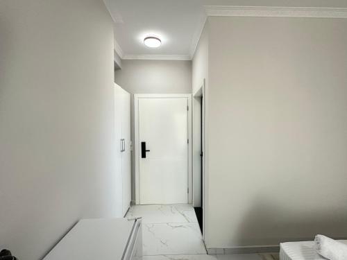 an empty hallway with a white door in a room at LiEl Holiday in Vlorë