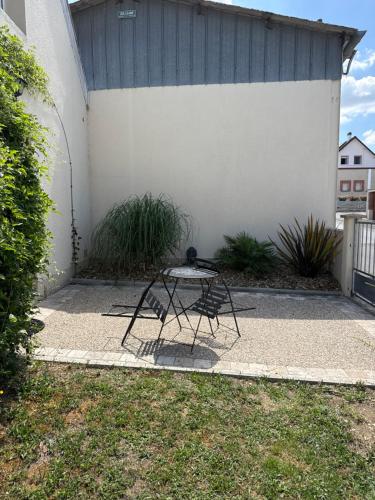 a table sitting on a sidewalk in front of a building at Home in Oiry in Oiry