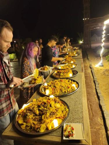 a line of plates of food on a table at Ciao Hotel in Nuweiba
