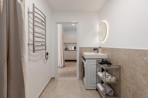 a bathroom with a shower and a sink and a mirror at P6-A Riga Old Town Apartments in Rīga