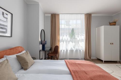 a bedroom with a white bed and a window at P6-A Riga Old Town Apartments in Rīga