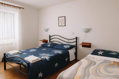 a bedroom with a bed and a chair in it at Hiša Vanda in Dobrovo